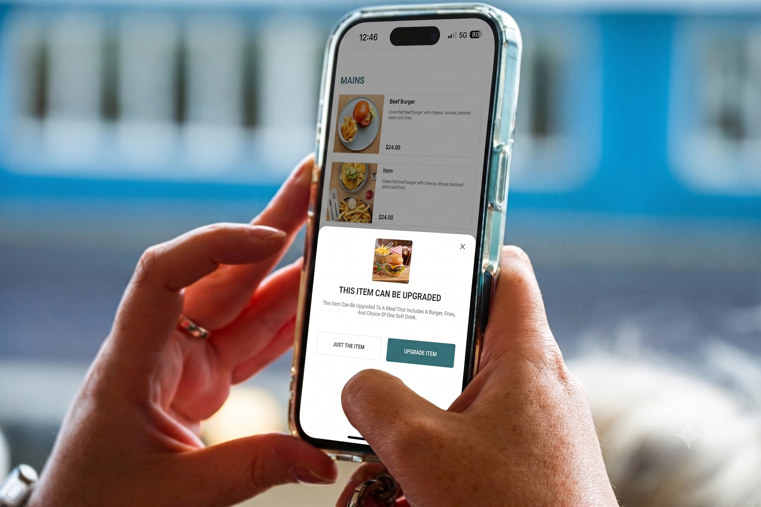 Hands holding a phone showing Mondo Connex mobile meal upgrade prompt